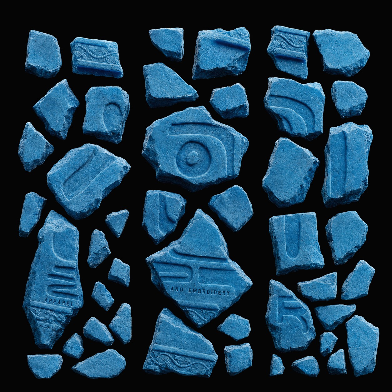 Fragments of carved blue stone arranged in a grid, each bearing part of the LOUZER sigil