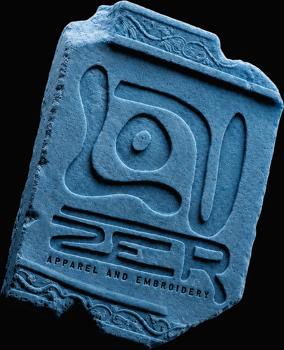 A carved blue stone tablet bearing the LOUZER sigil